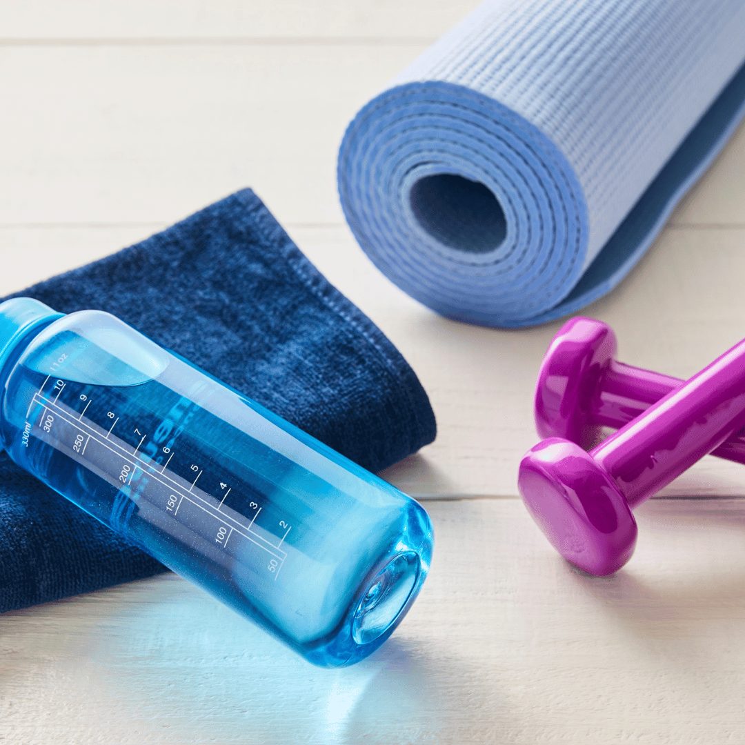 Water bottle, towel and dumbbells for a personal training session